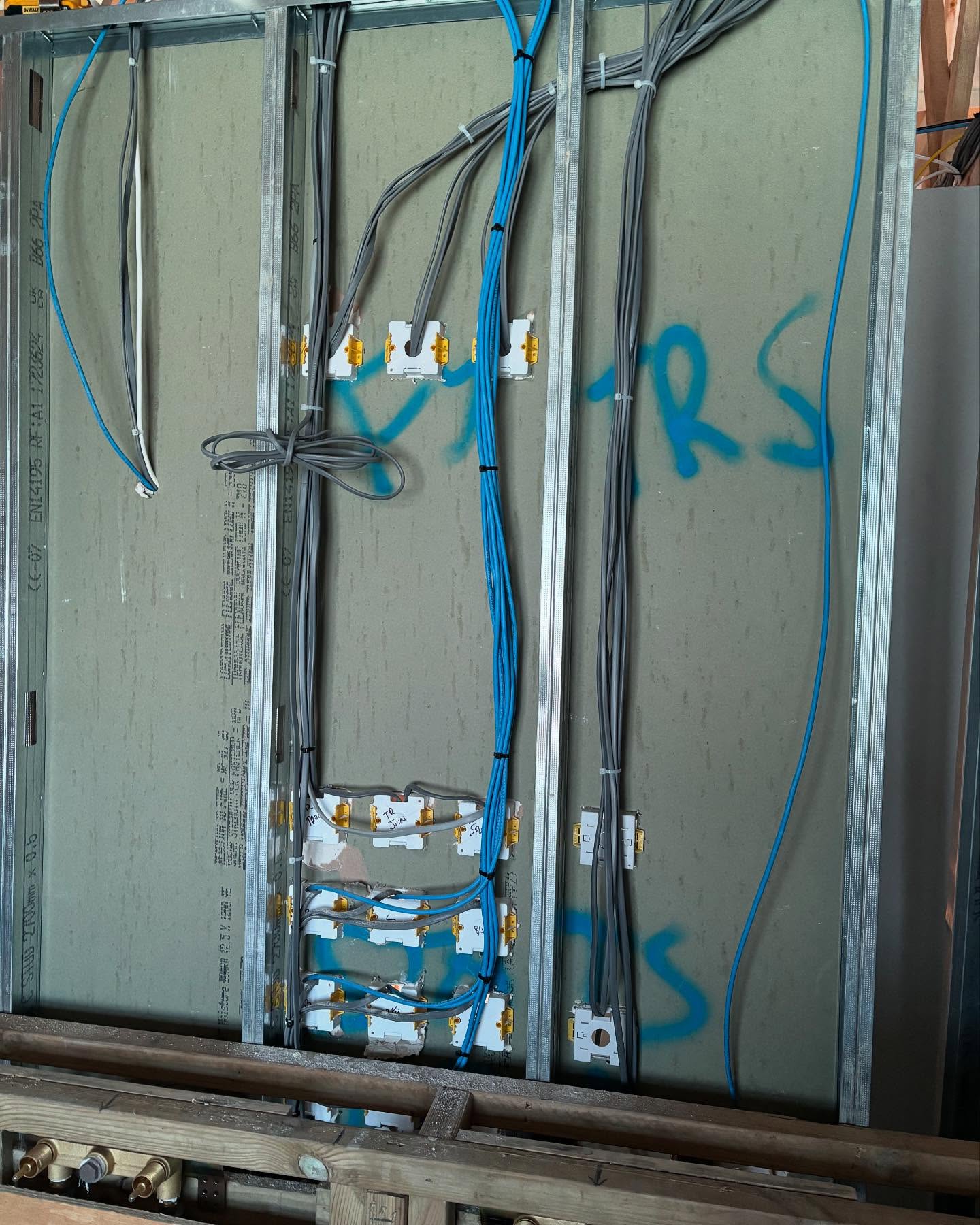 What the inside of a wall looks like, the cables you see here are a combination of power (Grey) for extractor fans, loft lights, heating manifolds and thermostats and the data (blue) from the floor sensors to the thermostats #electrician #oxted #edenbridge #eastgrinstead #lingfield